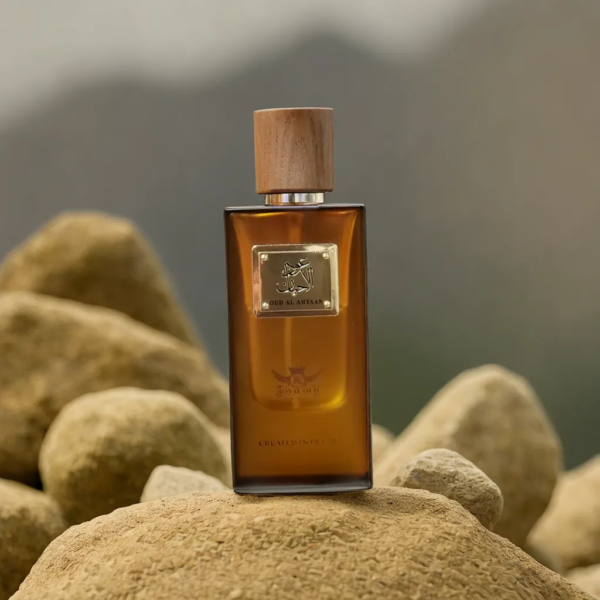 Bottle of oud al ahyaan sitting on top of a pile of rocks