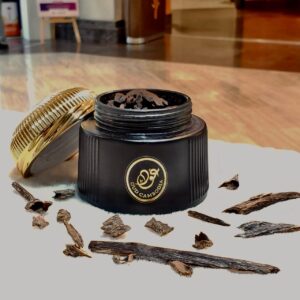 Black box with gold lid of bakoor / incence - tradtional wooden chips with perfume oil